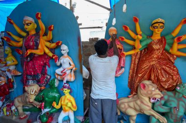 GURGRAM INDIA OCTOBER 6 2024 55 year old Ashok Baidyi artists from Nadia District West Bengal are making eco friendly idols of Goddess Durga for the upcoming Durga Puja festival at a workshop in Chakkarpur village near Government Senior Secondary Sch clipart