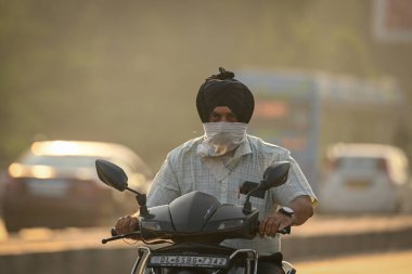 NEW DELHI INDIA OCTOBER 15 2024 Commuters seen during early morning haze as the pollution levels gets increased at Kirti Nagar on October 15 2024 in New Delhi India Air in Delhi NCR is worsening as the seasons change With temperatures dropping and po clipart