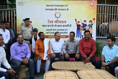 NEW DELHI INDIA OCTOBER 15 2024 DRM Sukhwinder Singh with other railway officers and passengers participate in Swachhta Hi Seva campaign during Railway Chopal in Delhi Division Northern Railway at New Delhi Railway Station Ajmeri Gate side on October clipart