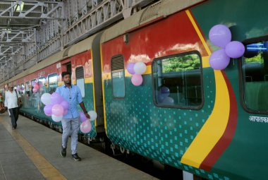 MUMBAI INDIA JUNE 1 2023 Commuters celebrate the birthday of Deccan Queen the Indian Railways first deluxe train as it completed 93 glorious years of operations between Pune and Mumbai at CSMT Railway Station on June 1 2023 in Mumbai India Photo by B clipart