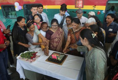 MUMBAI INDIA JUNE 1 2023 Commuters celebrate the birthday of Deccan Queen the Indian Railways first deluxe train as it completed 93 glorious years of operations between Pune and Mumbai at CSMT Railway Station on June 1 2023 in Mumbai India Photo by B clipart