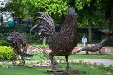 NEW DELHI, INDIA: JUNE 4 2023 - Birds and animals made from scrap metal seen placed inside a park ahead of the preparations for G20 Summit at Chanakyapuri.  clipart