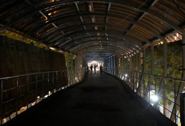 MUMBAI INDIA JUNE 10 2023 Streetlights under the skywalk and inside the skywalk are non functional while some pillars of the skywalk are seen illuminated with colorful lightings as part of the BMC beautification project on S V Road at Borivali West o clipart