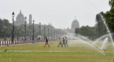 NEW DELHI INDIA JUNE 12 2023 Commuters seen out on a hot summer day at Kartavya path as the heat wave conditions prevailed in Northern India with the maximum temperature settling at 40 degrees Celsius on June 12 2023 in New Delhi India Photo by Sonu  clipart