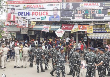 NEW DELHI INDIA JUNE 16 2023 Security personnel deployed outside the Coaching center where a massive fire was broke out yesterday at Mukherjee Nagar on June 16 2023 in New Delhi India Sixty one students were injured while trying to escape a four stor clipart