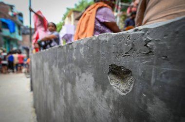 NEW DELHI INDIA JUNE 18 2023 Bullet marks seen on the spot where two women were allegedly shot dead by unidentified men over money settlement issue at Ambedkar Basti RK Puram on June 18 2023 in New Delhi India The incident took place in the early hou clipart