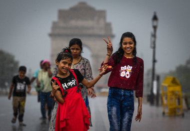 NEW DELHI INDIA JUNE 19 2023 Commuters out in the rain at Kartavya path on June 19 2023 in New Delhi India The city received 5mm of rainfall during the 24 hour period which ended at 8 30am on Monday The minimum temperature settled at 25 5 degrees Cel clipart