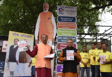 NEW DELHI INDIA JUNE 19 2023 National General Secretary BJP Dushyant Kumar Gautam and Former Union Minister Vijay Goel spearhead the 9 year s achievement of the Modi Government by beating Drums at Palika Bazar gate no1 Rajiv Chowk Connaught Place on  clipart