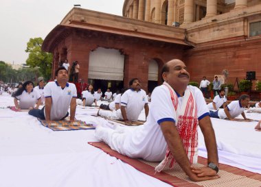 NEW DELHI INDIA JUNE 21 2023 Lok Sabha Speaker Om Birla with Lok Sabha and Rajya Sabha officials performs yoga during a session on the International Day of Yoga at the Parliament House complex on June 21 2023 in New Delhi India Photo by Sonu Mehta Hi clipart