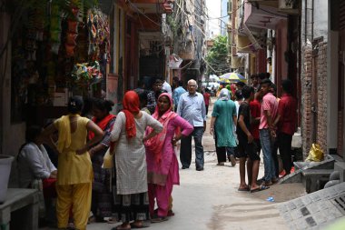 NEW DELHI INDIA JUNE 24 2023 Locals gathered around the residence of Rahul a 20 year old who along with his cousin was allegedly stabbed by a person yesterday following an argument over a petty issue at Brij Puri on June 24 2023 in New Delhi India Tw clipart