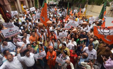 NEW DELHI INDIA JUNE 24 2023 Virendra Sachdeva President of Delhi BJP along with LOA Ramvir Singh Bidhuri and party workers and supporters protest against the Delhi Jal Board over the supply of alleged bad quality of water in the city at Varunalaya C clipart