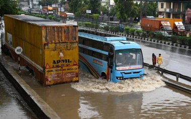 GURUGRAM INDIA JUNE 25 2023 Vehicle drive through a waterlogged stretch after heavy rains at National Highway 48 near Narsinghpur village on June 25 2023 in Gurugram India Heavy rainfall accompanied by lightning lashed several parts of the national c clipart