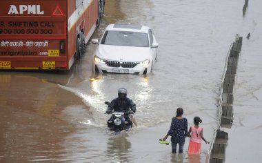 GURUGRAM INDIA JUNE 25 2023 A BMW car stuck in water logged service lane amid heavy rain at National Highway 48 near Narsinghpur village foot over bridge on June 25 2023 in Gurugram India Heavy rainfall accompanied by lightning lashed several parts o clipart