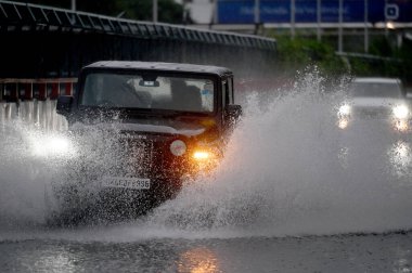 NOIDA INDIA JUNE 25 2023 Commuters pass through a heavily waterlogged stretch of road at Sector 28 on June 25 2023 in Noida India Heavy rainfall accompanied by lightning lashed several parts of the national capital Delhi and its adjoining areas in th clipart