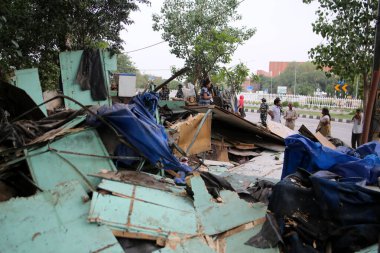 NEW DELHI INDIA JUNE 1 2023 People are seen next to demolished makeshifts after an anti encroachment drive being carried near Pragati Maidan by PWD at Bhairon Marg on June 1 2023 in New Delhi India The government s public works department PWD on Thur clipart