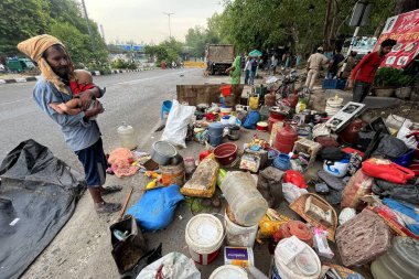 NEW DELHI INDIA JUNE 1 2023 People are seen next to demolished makeshifts after an anti encroachment drive being carried near Pragati Maidan by PWD at Bhairon Marg on June 1 2023 in New Delhi India The government s public works department PWD on Thur clipart