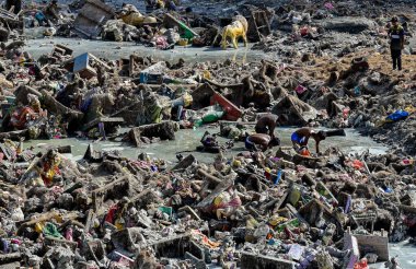 MUMBAI INDIA JUNE 6 2023 Remains of last year s Ganpati idols immersed at Teen Talao in Chembur resurface as the lake is drained for maintenance Here children can be seen scouring through the muddy water to salvage bits and pieces of scrap on June 6  clipart