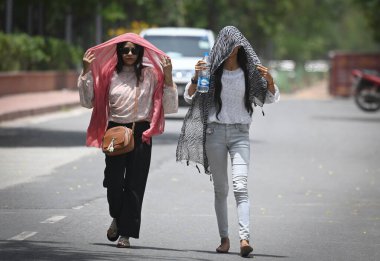 NEW DELHI INDIA JUNE 12 2023 Commuters out on a hot summer day near Rajghat area on June 12 2023 in New Delhi India India is witnessing heatwaves in various parts of the country in recent days Photo by Raj K Raj Hindustan Times clipart