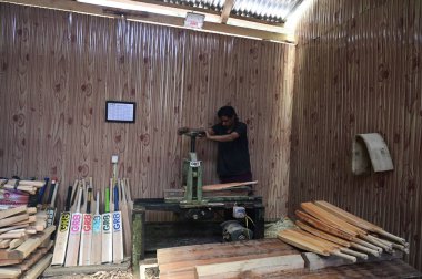 SRINAGAR INDIA JUNE 12 2023 A laborer works in a GR8 cricket bat manufacturing unit in Sangam some 38 kilometers south of Srinagar on June 12 2023 in Srinagar India GR8 bat manufacturers have received an order for bats to be used during the 2023 One  clipart