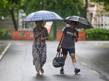 NOIDA INDIA JUNE 16 2023 Commuters out in the light rain on the Sector 21A road on June 16 2023 in Noida India The India Meteorological Department had predicted light rain with gusty winds in Delhi NCR on Thursday According to the weather department  clipart