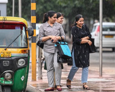 NEW DELHI INDIA JUNE 17 2023 Commuters out in the rain at connaught place area on June 17 2023 in New Delhi India The India Meteorological Department had predicted light rain with gusty winds in Delhi NCR on Thursday According to the weather departme clipart