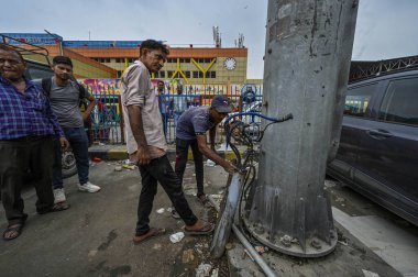 NEW DELHI INDIA JUNE 26 2023 Workers Repairing the an open electric circuit breaker box or a breaker box at New Delhi Railway station parking Area on June 26 2023 in New Delhi India A 35 year old woman who stepped onto a flooded street at the New Del clipart