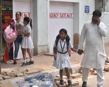 NEW DELHI INDIA APRIL 26 2023 Parents with their children leave after receiving a bomb threat at Delhi Public School DPS Mathura Road on April 26 2023 in New Delhi India A 16 year old teenager who sent the hoax bomb mail to Delhi Public School on Apr clipart