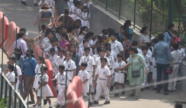 NEW DELHI INDIA APRIL 26 2023 Parents with their children leave after receiving a bomb threat at Delhi Public School DPS Mathura Road on April 26 2023 in New Delhi India A 16 year old teenager who sent the hoax bomb mail to Delhi Public School on Apr clipart