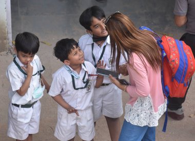 NEW DELHI INDIA APRIL 26 2023 Parents with their children leave after receiving a bomb threat at Delhi Public School DPS Mathura Road on April 26 2023 in New Delhi India A 16 year old teenager who sent the hoax bomb mail to Delhi Public School on Apr clipart