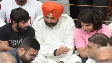 NEW DELHI INDIA MAY 1 2023 Congress Leader Navjot Singh Sidhu Talking with Wrestlers Bajrang Punia Sakshi Malik and others during the Ninth day dharna their protest against the Wrestling Federation of India president Brij Bhushan Saran at Jantar Mant clipart