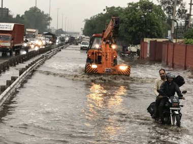 GURUGRAM INDIA MAY 3 2023 Vehicles wade through a waterlogged stretch between Khandsa to Narsighpur village in rain on the NH 48 service road near Shani Mandir on May 3 2023 in Gurugram India Photo by Parveen Kumar Hindustan Times clipart