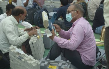 GHAZIABAD INDIA MAY 10 2023 Polling officials are seen collecting Electronic Voting Machines EVMs and other election materials for the second phase of the Municipal election at a distribution center in Kamla Nehru Nagar on May 10 2023 in Ghaziabad In clipart