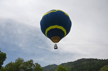 SRINAGAR INDIA MAY 12 2023 Tourists enjoy a hot air balloon ride during a G20 event organised by the Jammu and Kashmir Tourism Deparment at Zabarwan Park on the banks of Dal Lake on May 12 2023 in Srinagar India The department is organising hot air b clipart