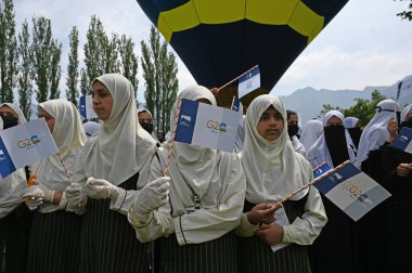 SRINAGAR INDIA MAY 12 2023 Students participate at a G20 event organised by the Jammu and Kashmir Tourism Deparment at Zabarwan Park on the banks of Dal Lake on May 12 2023 in Srinagar India The department is organising hot air balloon rides cycling  clipart