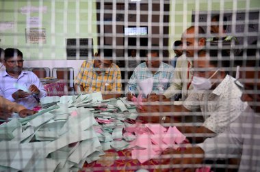 GREATER NOIDA INDIA MAY 13 2023 Election Commission staff counting Ballot paper of local bodies election votes at Mihir Bhoj PG College in Dadri on May 13 2023 in Greater Noida India The Bhartiya Janata Party swept the Uttar Pradesh local body polls  clipart