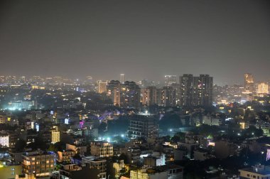 GURUGRAM, INDIA OCTOBER 30 2024 The Gurugram city DLF area is illuminated on the eve of Diwali festival on October 30 2024 in Gurugram India  clipart