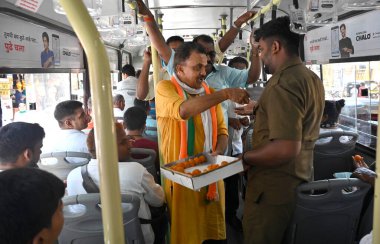 MUMBAI INDIA MAY 14 2023 Mumbai Congress President Bhai Jagtap and party leader Sanjay Nirupam along with party workers celebrate the party s victory in Karnataka assembly elections by distributing sweets at Andheri on May 14 2023 in Mumbai India Con clipart