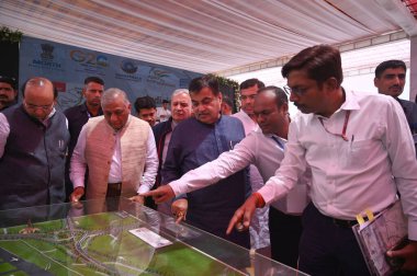 GURUGRAM INDIA MAY 18 2023 Nitin Gadkari Union minister for road transport and highways and VK Singh Union Minister of State for Civil Aviation and Road Transport and Highways seeing the layout plan of Dwarka expressway at National Highway 48 cloverl clipart