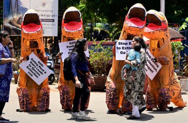 MUMBAI INDIA MAY 19 2023 PETA volunteers dressed as dinosaurs make an appeal to the upcoming G20 working group to go vegan at Horniman Circle on May 19 2023 in Mumbai India Photo by Anshuman Poyrekar Hindustan Times clipart