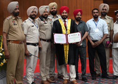 CHANDIGARH INDIA MAY 20 2023 Former Chief Minister Punjab Charanjit Singh Channi with his security staff after receiving the degree of Doctor of Philosophy during the 70th convocation ceremony at Punjab University clipart