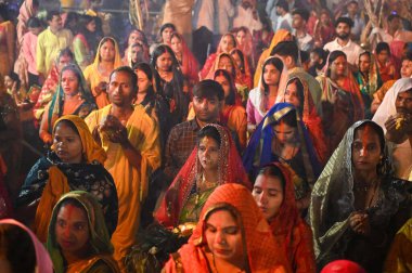 GURUGRAM INDIA NOVEMBER 8 2024 Hindu devotees offer prayers and performing rituals to the God Sun during rising to mark Chhath Puja Festival at Sheetla Mata Mandir parking site sector 5 road in Gurugram India on Friday 08 November 2024  clipart