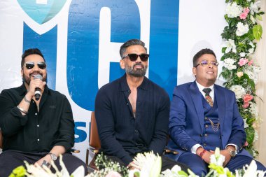 NEW DELHI INDIA OCTOBER 13 2024 Bollywood actor Suniel Shetty and singer Mika Singh with ICI founding member Dr Tarang Krishna Blue Coat during the inauguration of ICI Indian Cancer Institutes research and treatment hospital on October 13 2024  clipart