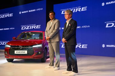 GURGRAM INDIA NOVEMBER 11 2024 R Hisashi Takeuchi MD and CEO and Partho Banerjee Head of Marketing and Sales at Maruti Suzuki has launched of the Maruti Suzuki India Ltd MSIL fourth generation Dzire compact sedan at Aerocity on November 11 2024 in Gu clipart