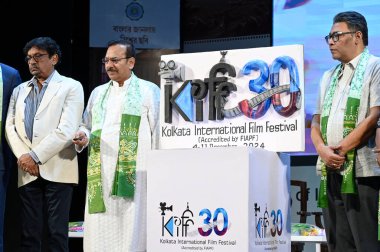 KOLKATA INDIA NOVEMBER 29 2024 L R Indian film director and KIFF chairman Goutam Ghose Sports minister Aroop Biswas and Information and Tourism minister Indranil Sen during logo unveiling of the 30th Kolkata International Film Festival KIFF on Novemb clipart