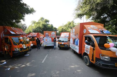 NEW DELHI, INDIA - DECEMBER 7, 2024: Delhi BJP inaugurated BJP election office by offering prayer, and launch vans to collect suggestion for Delhi BJP Sankalp Patra 2025, under the leadership of BJP Delhi President Virendra Sachdeva. clipart