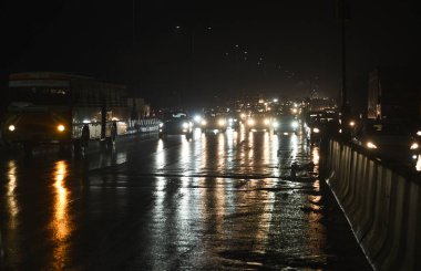 GHAZIABAD, INDIA - 8 ARALIK 2024: 19.30 sularında hafif yağmur yağışı oldu, yollar ıslandı. Ulusal Otoyol 9 Dasna, 8 Aralık 2024 tarihinde Hindistan 'ın Gaziabad kentinde. Pazar günü Delhi-NCR 'nin bazı bölgelerinde şiddetli yağış yaşandı. 