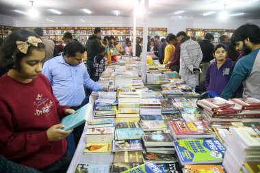 PATNA, INDIA - 8 Aralık 2024: Patna Kitap Fuarındaki bir tezgahta kitap severler 8 Aralık 2024 'te Patna, Hindistan' da