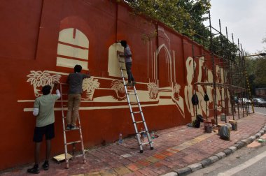 NEW DELHI INDIA APRIL 1 2023 Artists paint the wall of Delhi Universitys Indraprastha College for Women at Civil Lines on April 1 2023 in New Delhi India  clipart