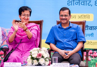 NEW DELHI INDIA APRIL 8 2023 Chief Minister of Delhi Arvind Kejriwal along with Atishi Marlena Delhi education minister during lay the foundation stone of new building blocks at Rajkiya Sarvodaya Kanya Bal Vidyalaya at East Vinod Nagar on April 8 202 clipart