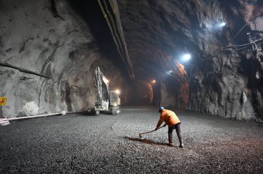 SRINAGAR, INDIA, APRIL 9, 2023 Construction workers work inside Asias longest bi directional Zojila Tunnel on the Srinagar Ladakh highway in the east of Srinagar on April 9 2023 in Srinagar, India  clipart